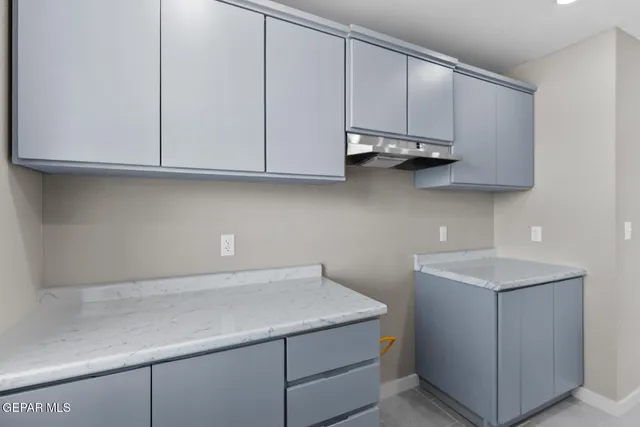 a kitchen with cabinets appliances and a sink