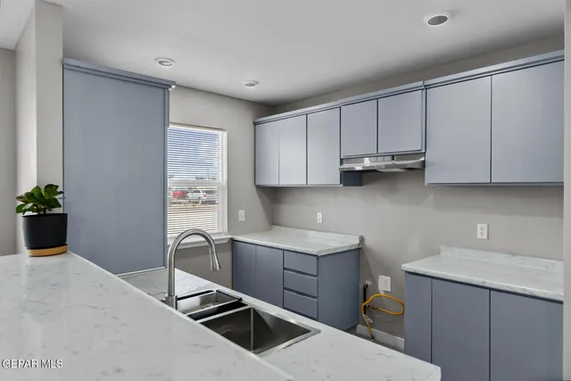 a kitchen with a sink cabinets and appliances