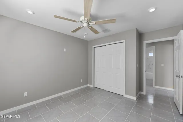 wooden floor in an empty room with a fan