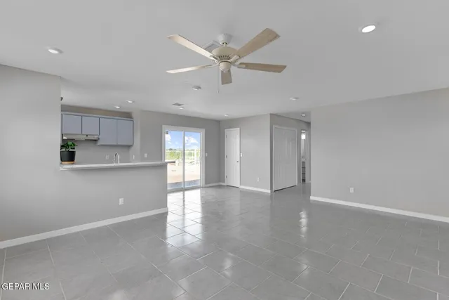a view of an empty room and window and wooden floor