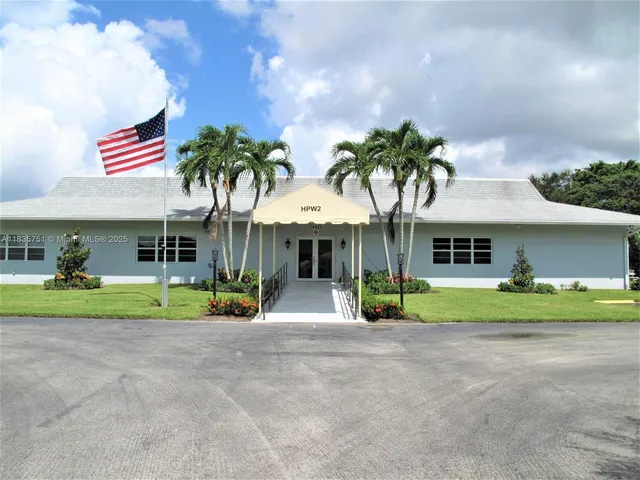 a room with pool table and windows