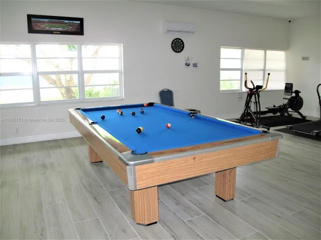 a room with gym equipment and windows