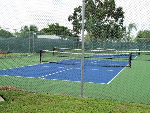 a view of a patio with table and chairs and potted plants