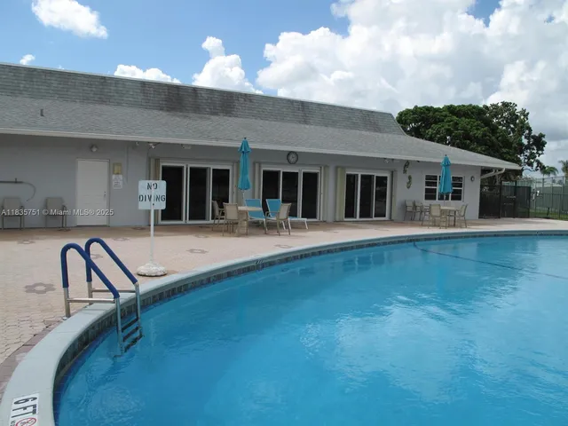 a view of a patio with a table and chairs