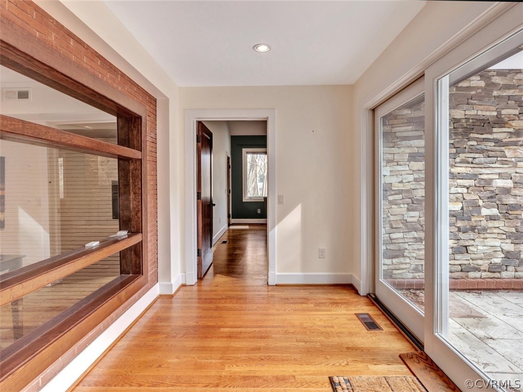 8010 Thom Road Henrico, VA 23229 - Photo 26 of 50 a view of a hallway with wooden floor and windows