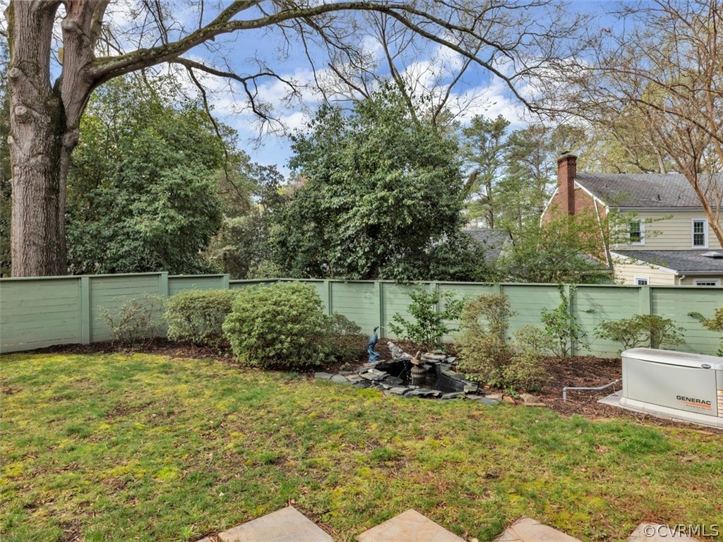 8010 Thom Road Henrico, VA 23229 - Photo 44 of 50 a backyard of a house with lots of green space and fountain