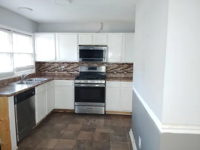 a kitchen with a stove and a microwave
