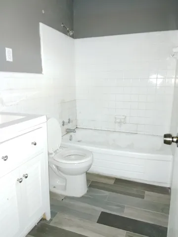 a bathroom with a toilet a sink and bathtub