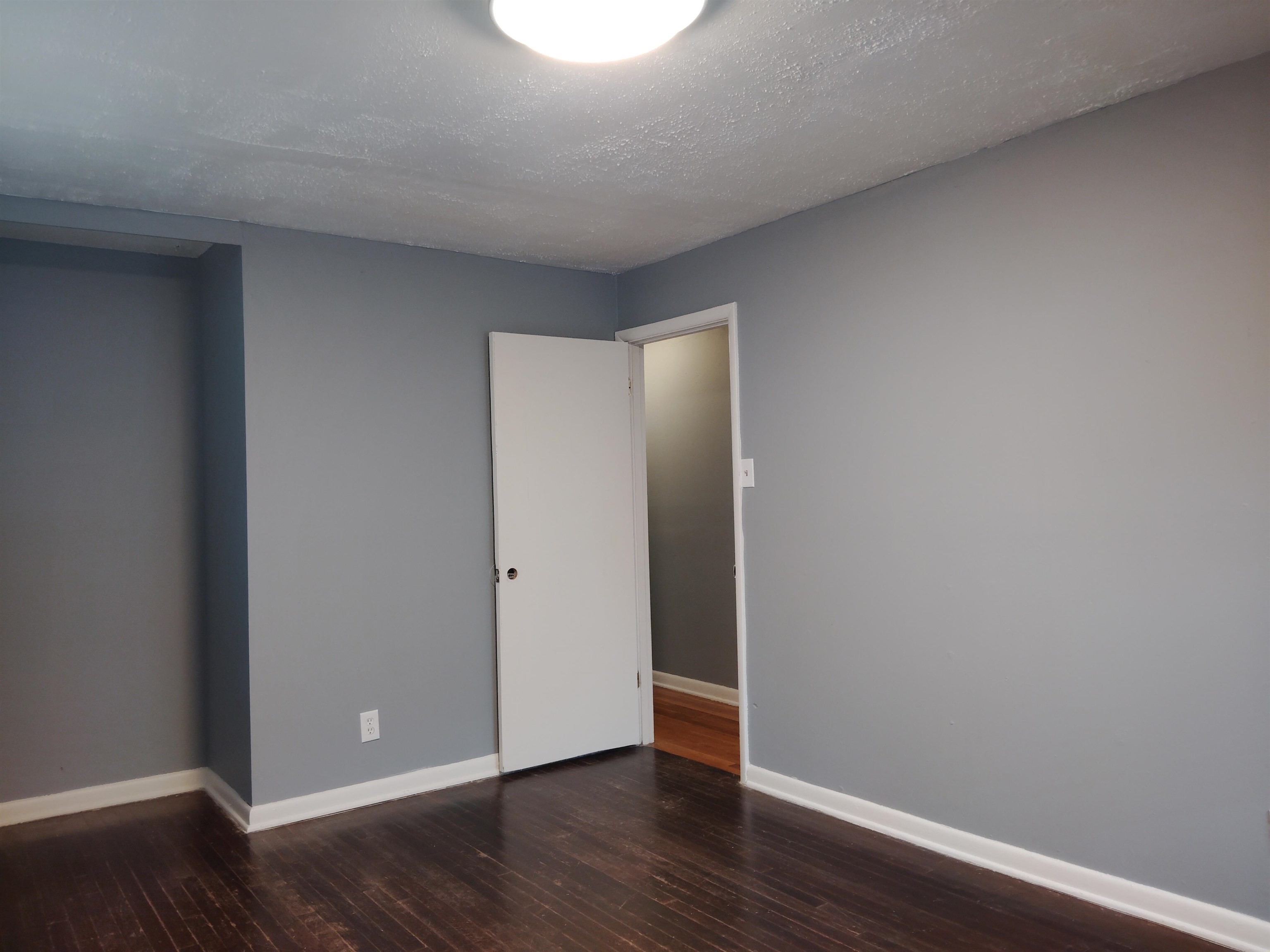4307 Sidney Road Memphis, TN 38116 - Photo 17 of 18 Unfurnished bedroom with dark wood-type flooring and a textured ceiling