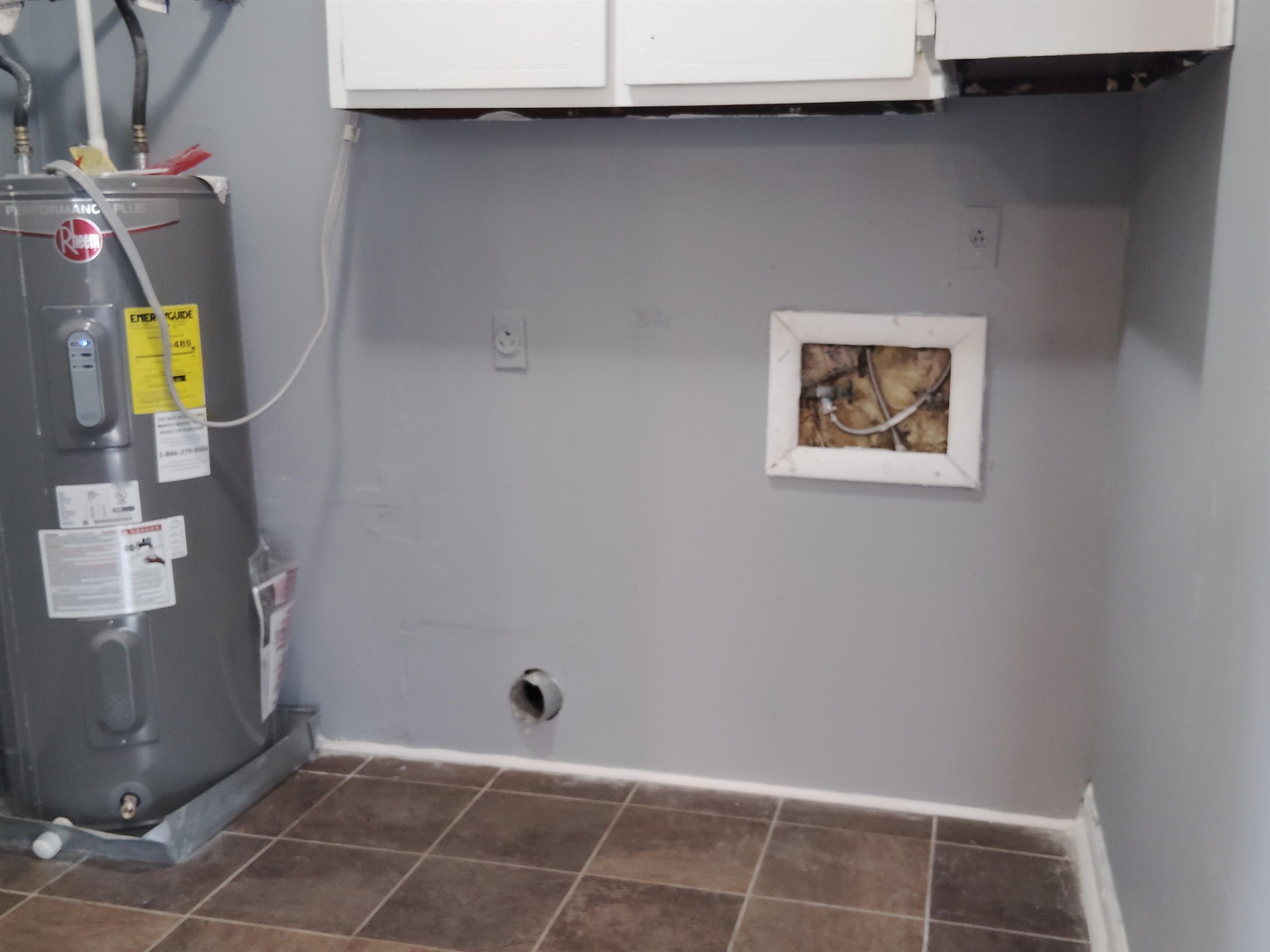 4307 Sidney Road Memphis, TN 38116 - Photo 9 of 18 Washroom with cabinet space, water heater, hookup for a washing machine, and dark tile patterned floors