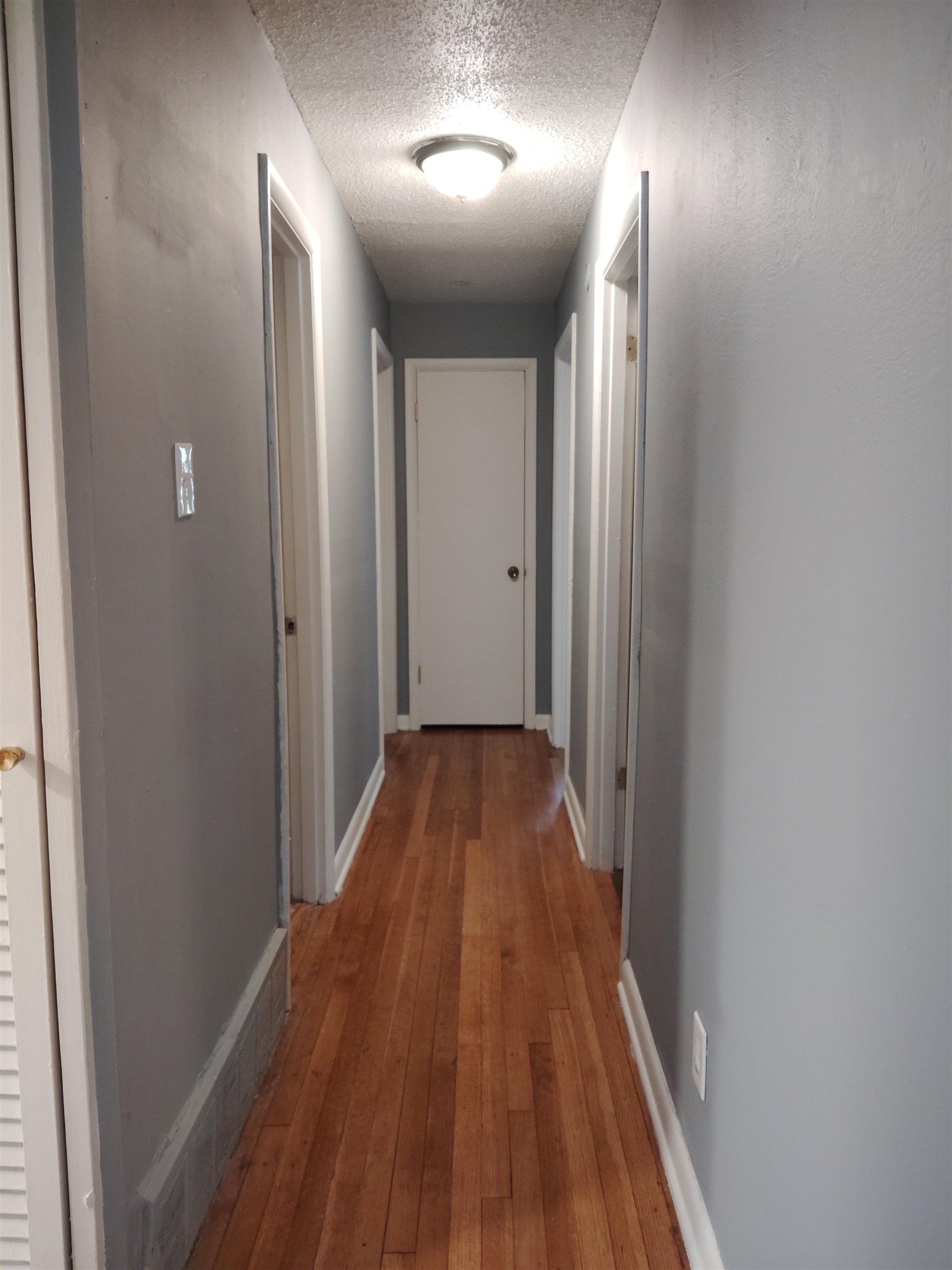 4307 Sidney Road Memphis, TN 38116 - Photo 10 of 18 Corridor featuring light wood-style floors and a textured ceiling