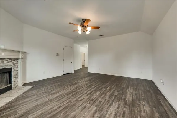 wooden floor in an empty room with a fireplace