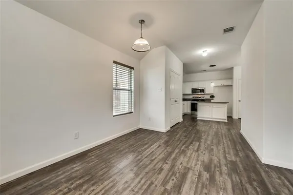 a view of kitchen and wooden floor