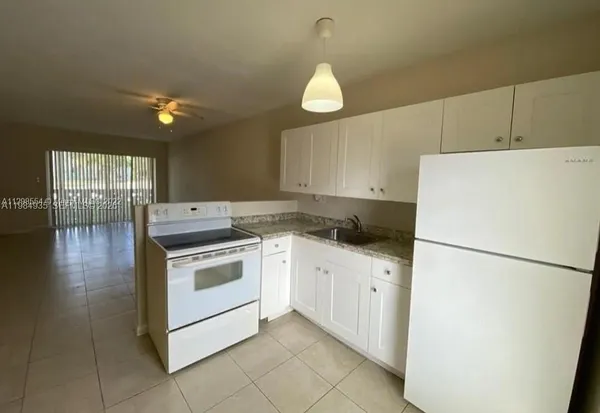 a kitchen with a white cabinets and white appliances