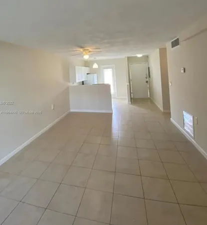 a view of a kitchen with a sink and a refrigerator