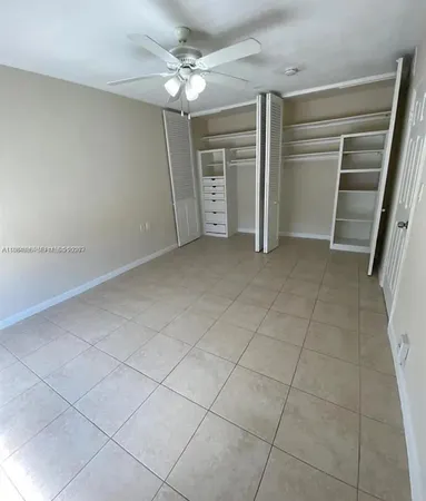 a view of an empty room with closet