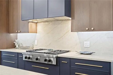 a stove top oven sitting inside of a kitchen