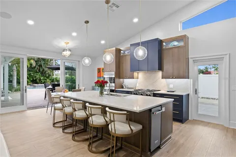 a large kitchen with a table and chairs