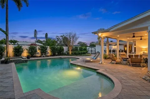 a view of a swimming pool with outdoor seating