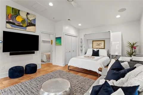 a bedroom with a bed and a flat screen tv