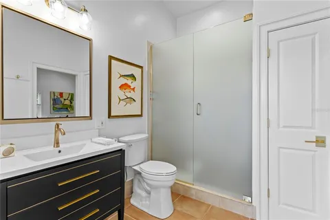 a bathroom with a sink a toilet a shower and a mirror