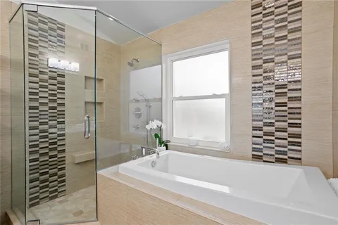 a bathroom with a bathtub and shower