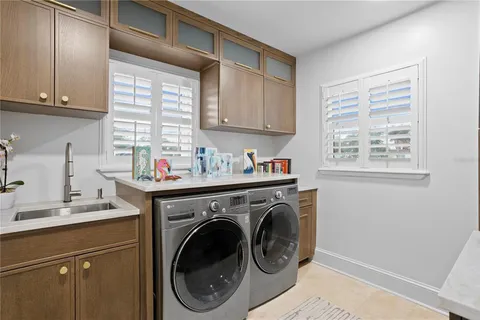 a utility room with sink dryer and washer