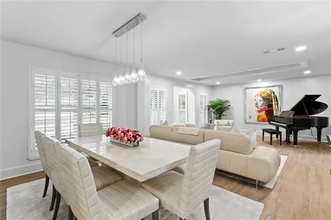 a living room with furniture and floor to ceiling windows
