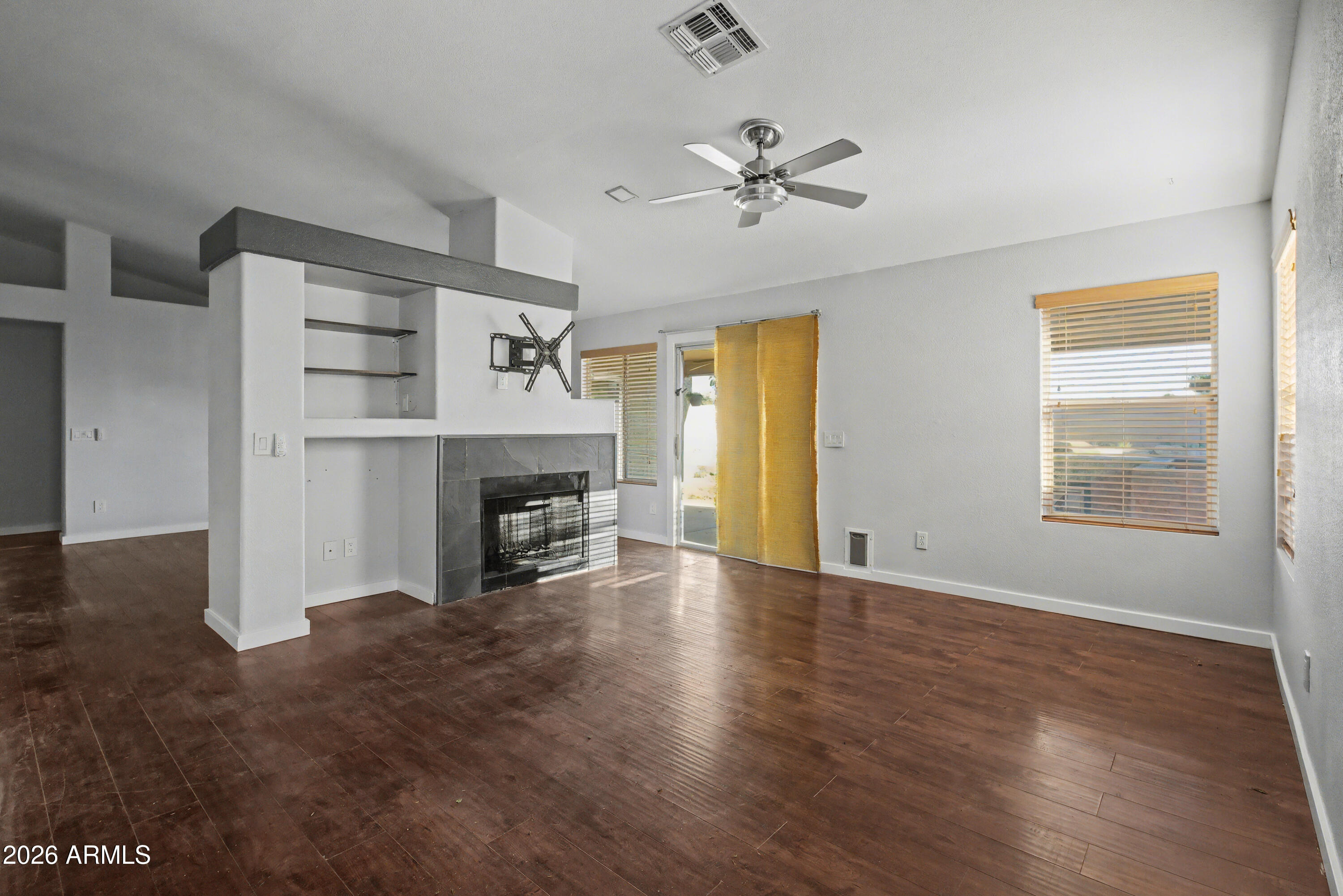 3925 West Charter Oak Road Phoenix, AZ 85029 - Photo 11 of 39 a view of a livingroom with a fireplace and window