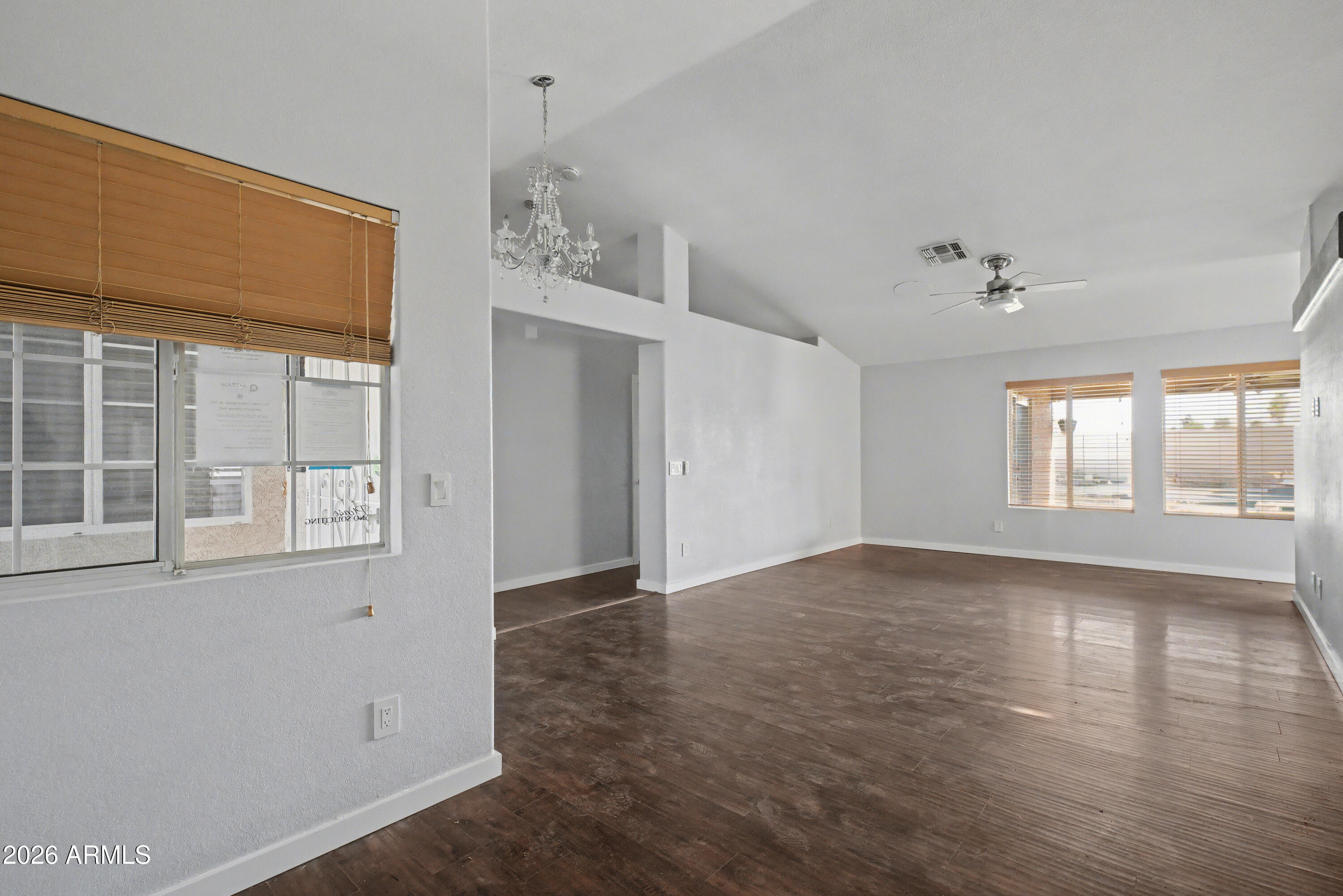 3925 West Charter Oak Road Phoenix, AZ 85029 - Photo 14 of 39 an empty room with wooden floor and windows
