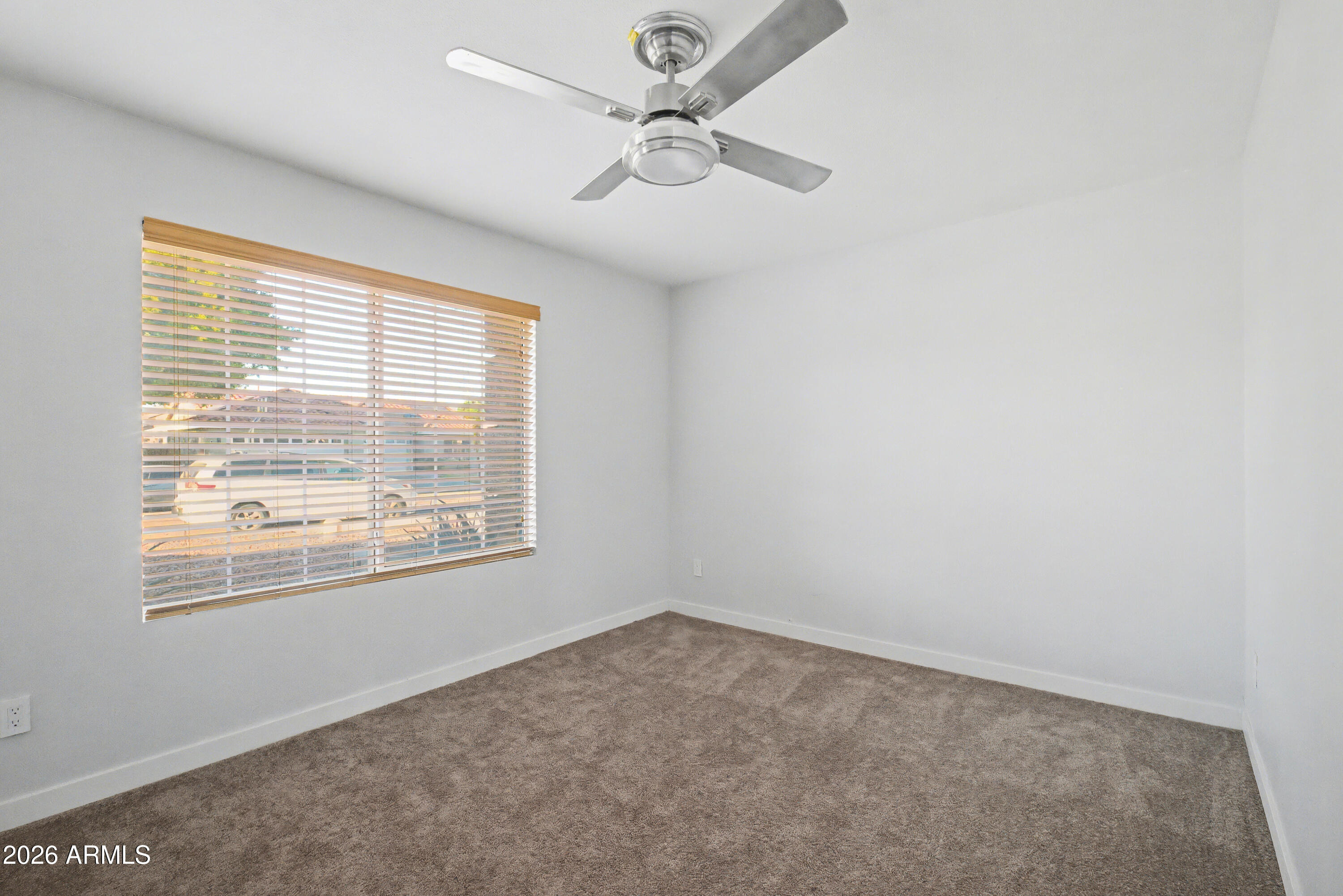 3925 West Charter Oak Road Phoenix, AZ 85029 - Photo 15 of 39 an empty room with windows and fan