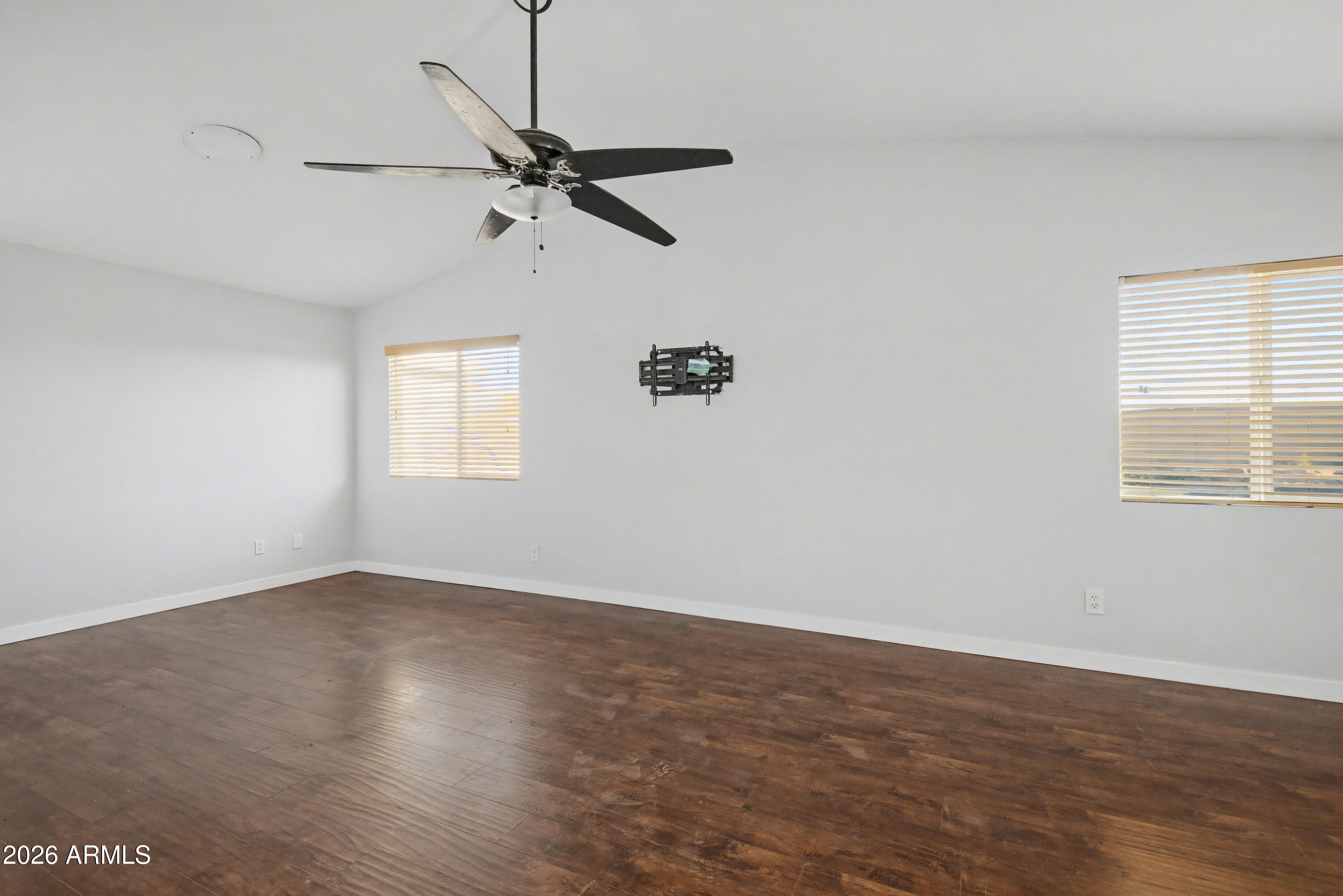 3925 West Charter Oak Road Phoenix, AZ 85029 - Photo 20 of 39 an empty room with wooden floor closet and windows