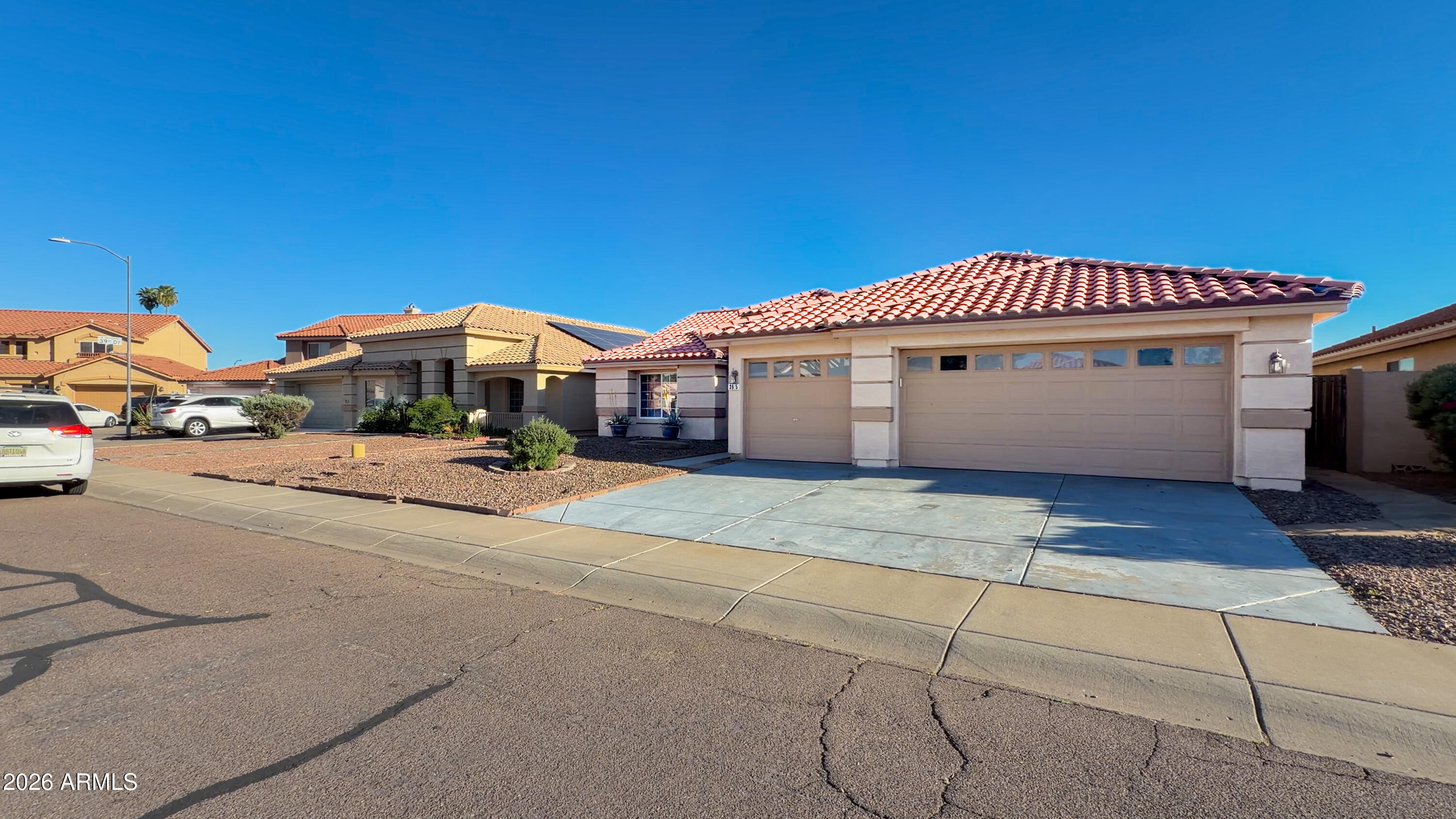 3925 West Charter Oak Road Phoenix, AZ 85029 - Photo 2 of 39 a front view of a house with a yard and garage