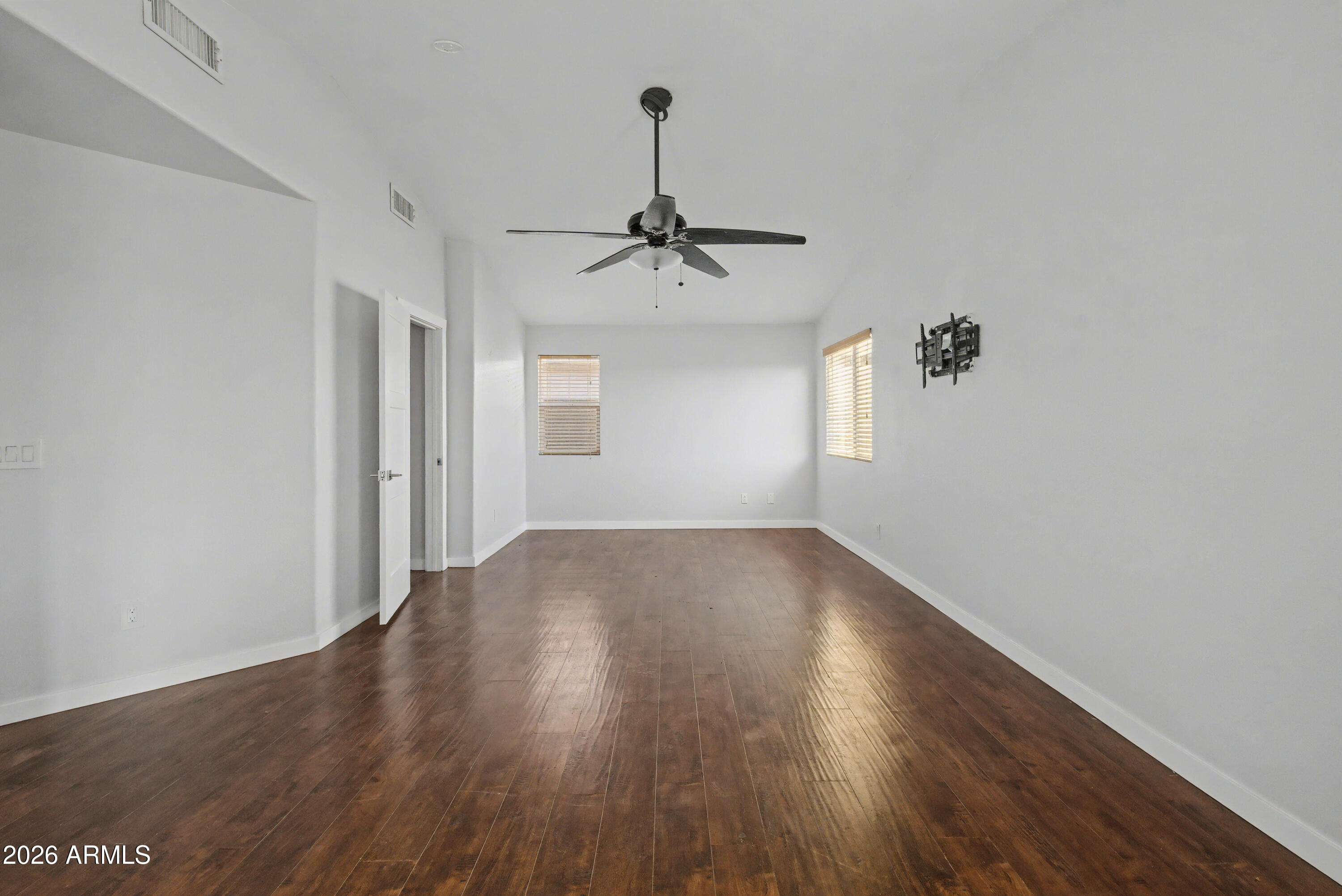 3925 West Charter Oak Road Phoenix, AZ 85029 - Photo 21 of 39 a view of a livingroom with wooden floor and a ceiling fan