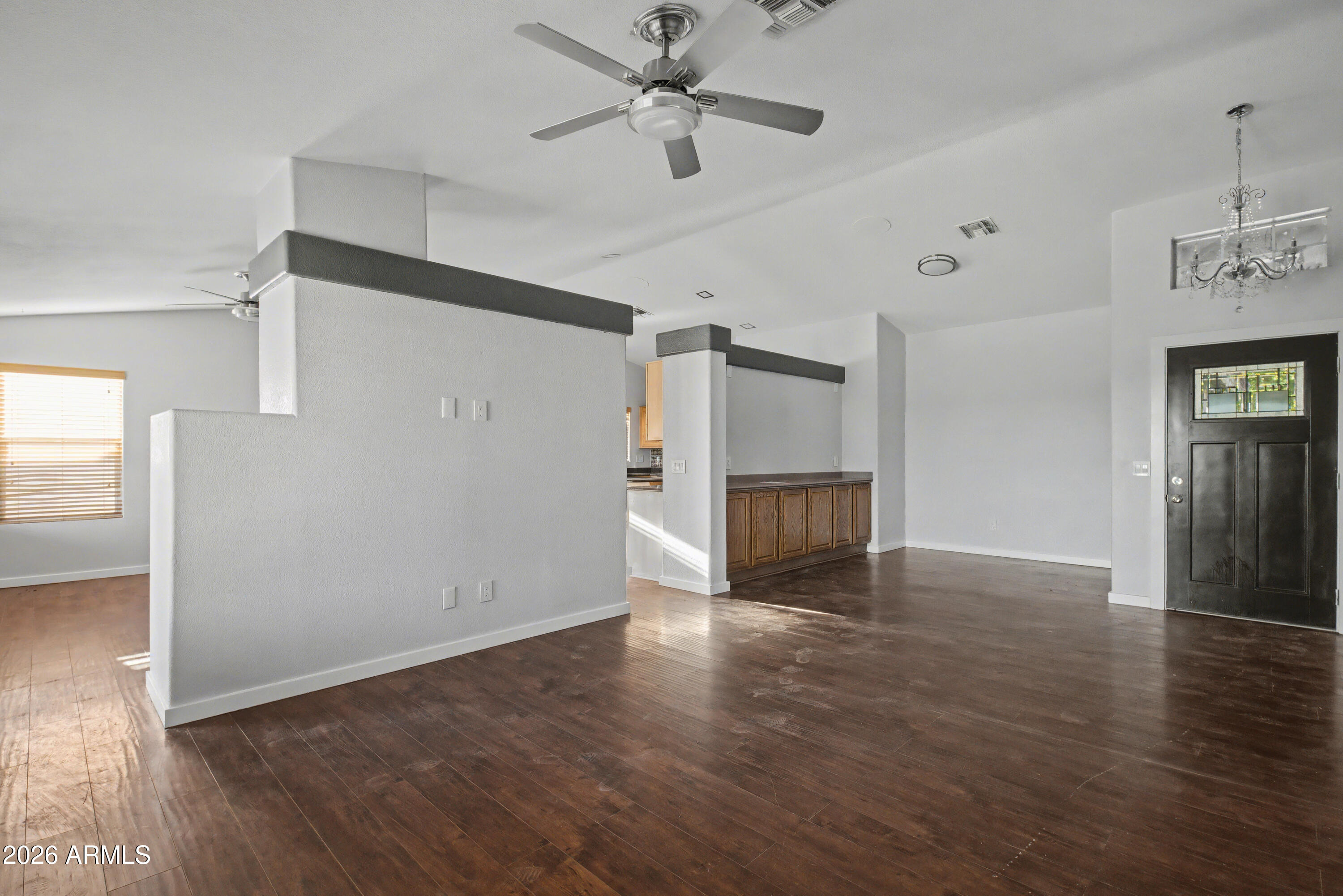 3925 West Charter Oak Road Phoenix, AZ 85029 - Photo 5 of 39 a view of an empty room with a window and wooden floor