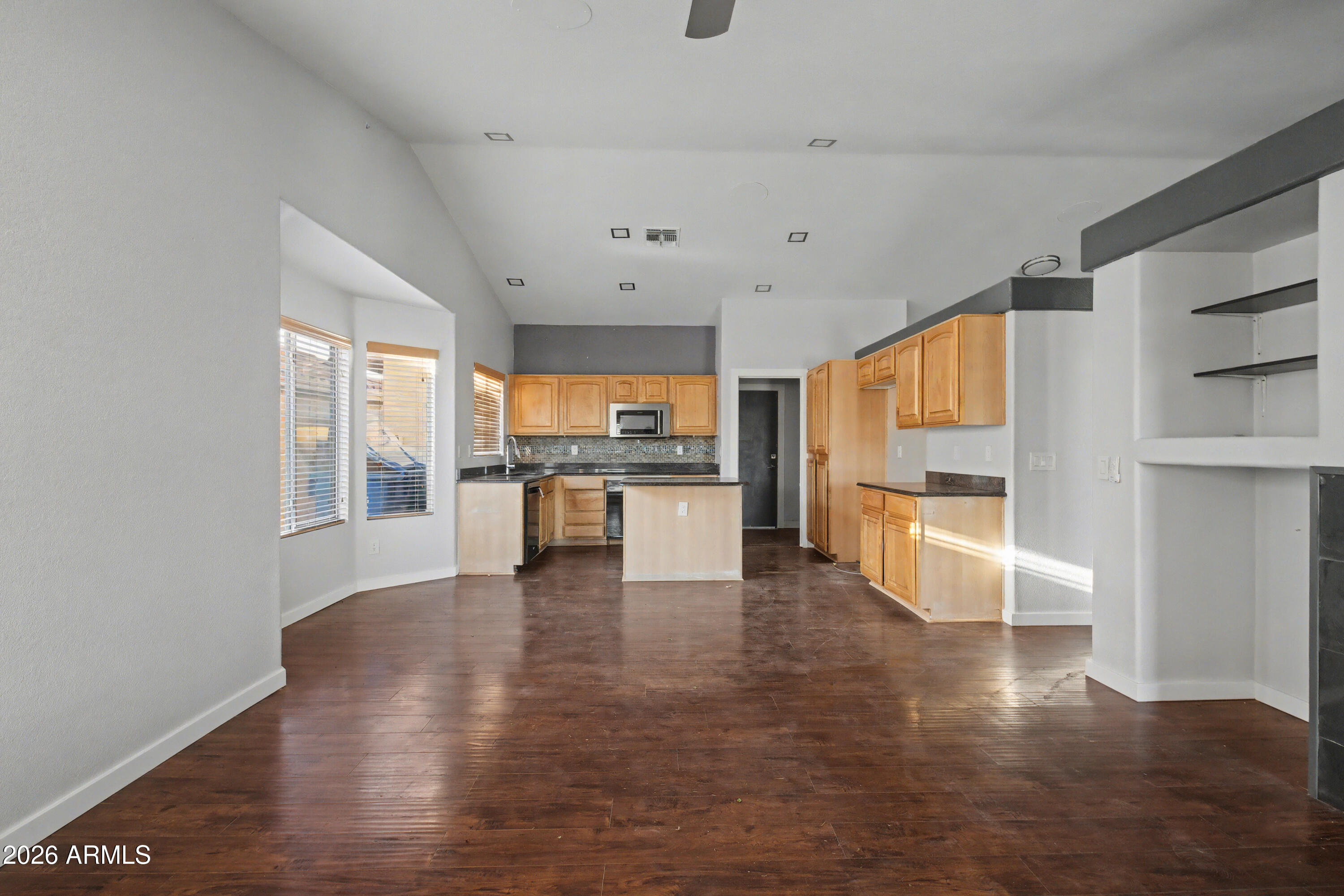 3925 West Charter Oak Road Phoenix, AZ 85029 - Photo 8 of 39 a large white kitchen with kitchen island a sink a stove and white cabinets