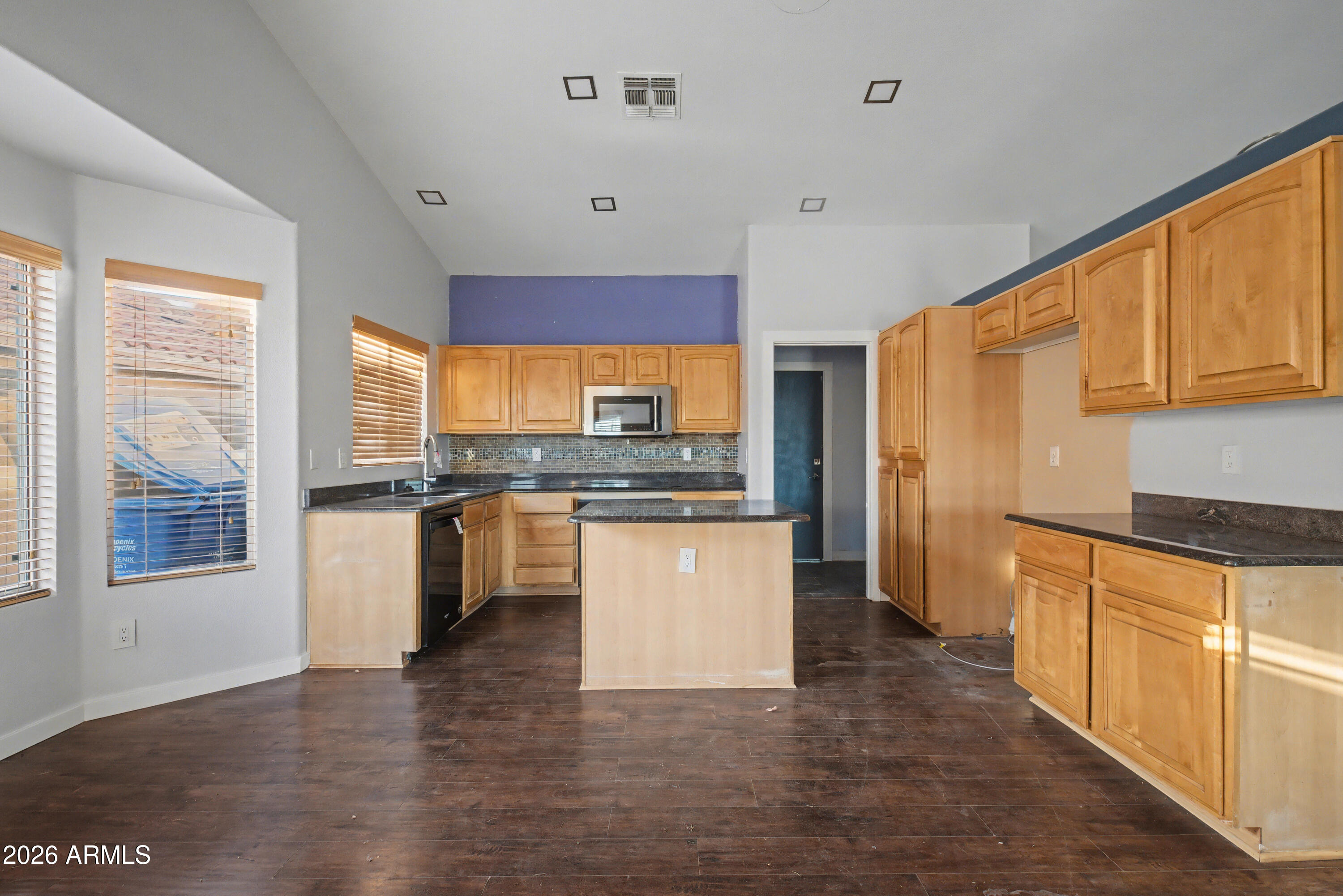 3925 West Charter Oak Road Phoenix, AZ 85029 - Photo 9 of 39 a kitchen with granite countertop wooden floors stainless steel appliances a sink and a window
