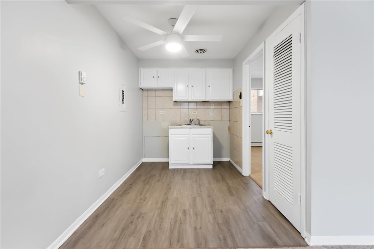 6256 West 64th Place, Unit 202 Chicago, IL 60638 - Photo 12 of 19 a view of a kitchen with wooden floor and a sink