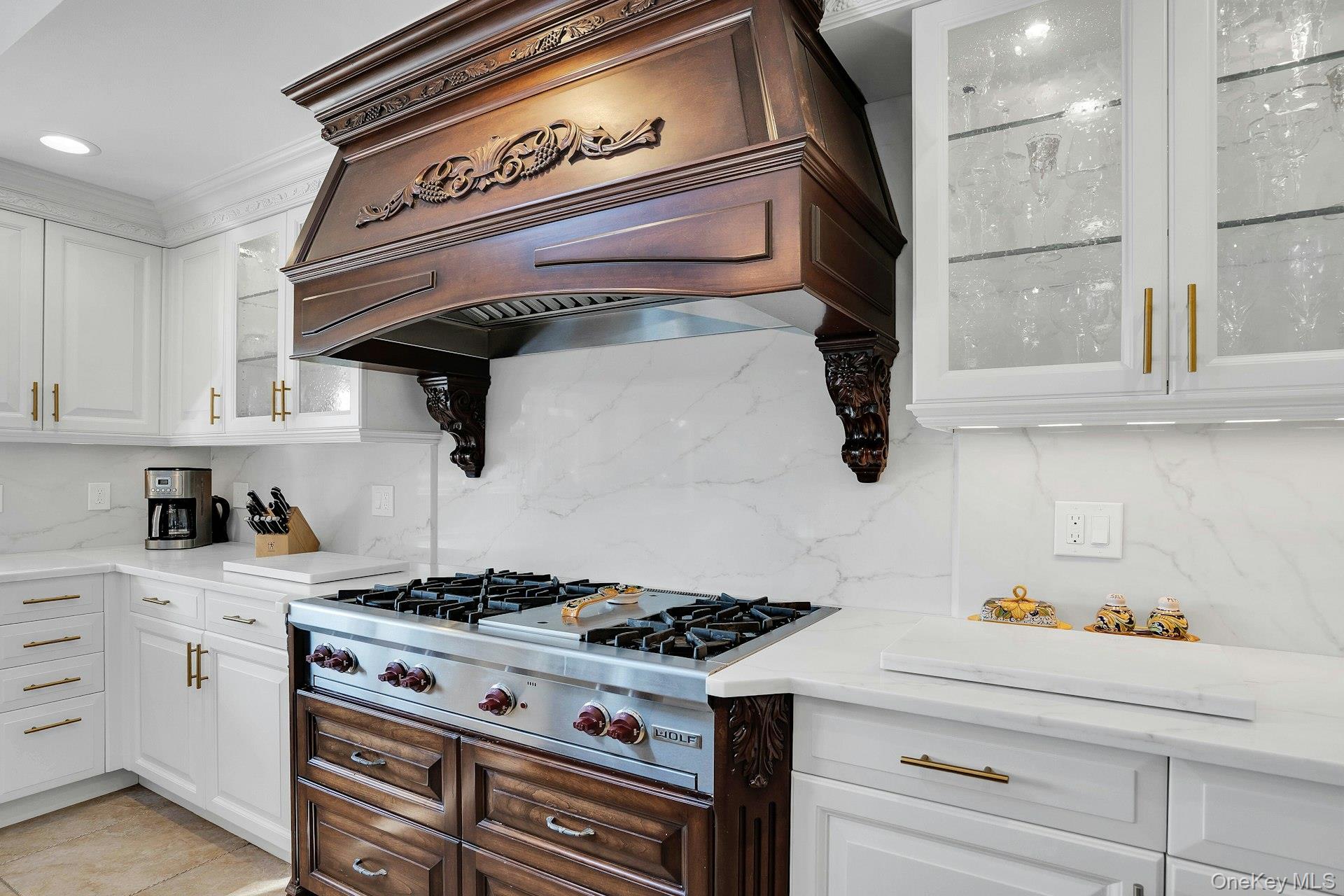 10 Beech Road Islip, NY 11751 - Photo 19 of 49 Wolf stove with 6 burners and grill. Custom carved hood is a showpiece.