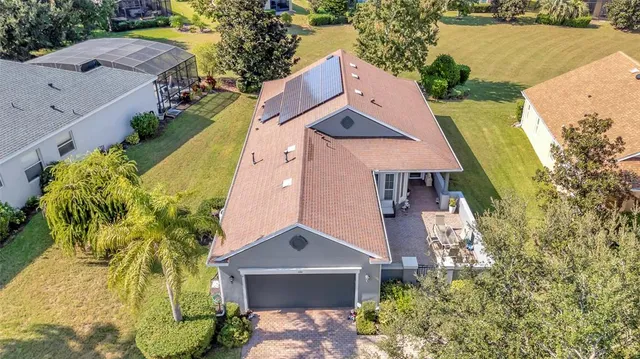 an aerial view of residential houses with outdoor space and swimming pool