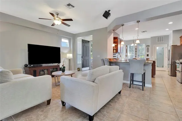 a living room with furniture a fireplace and a chandelier