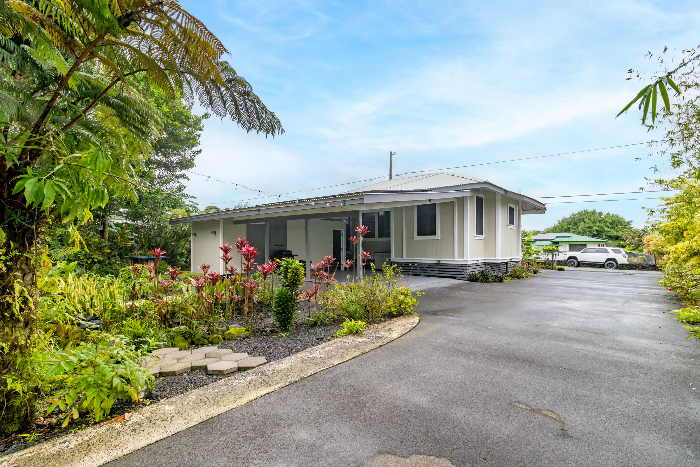 110 Malia Street Hilo, HI 96720 - Photo 26 of 27 a front view of a house with a yard and potted plants