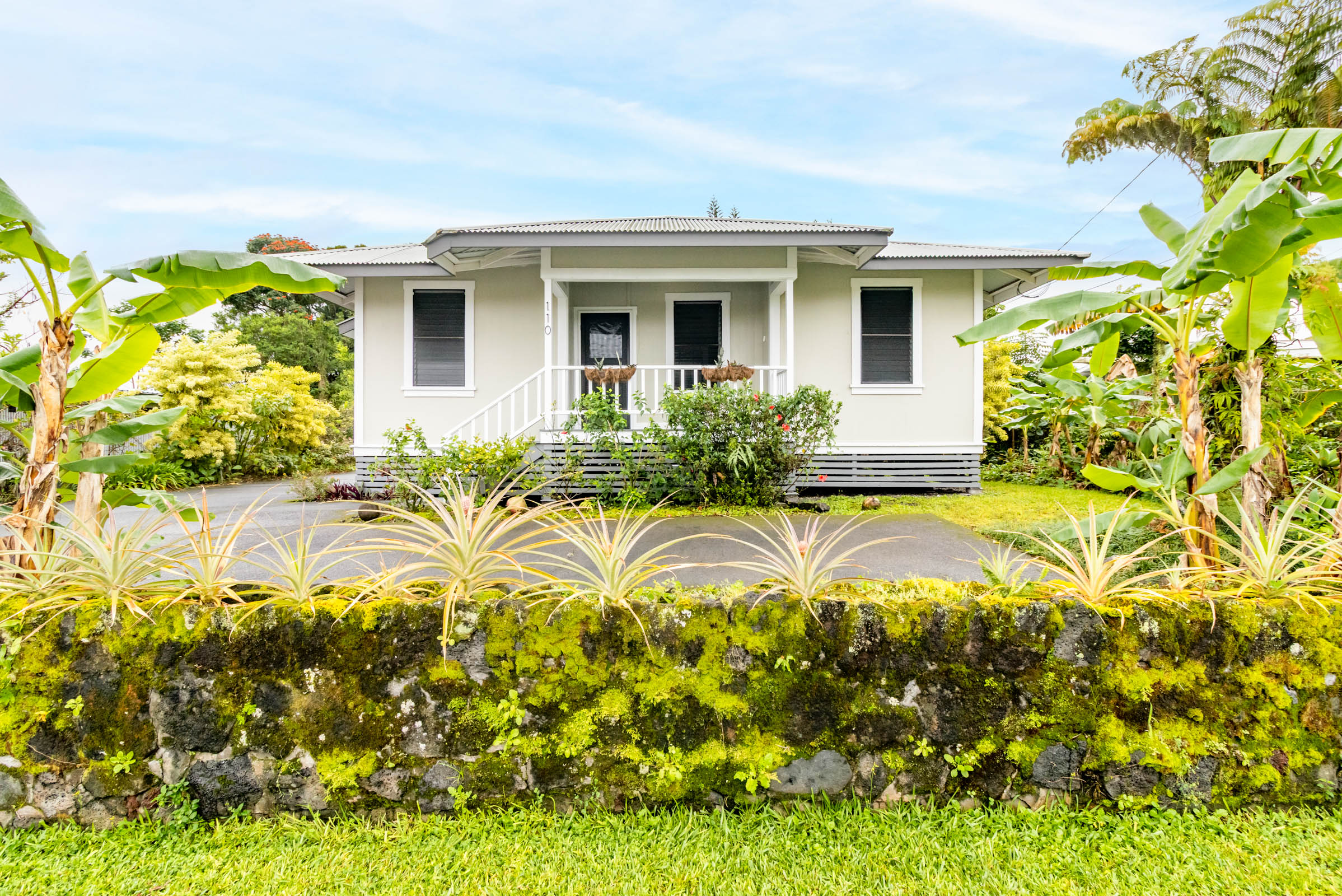 110 Malia Street Hilo, HI 96720 - Photo 3 of 27 a view of yellow house with a yard