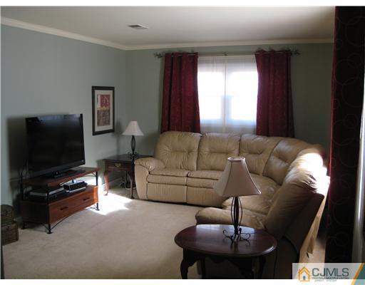 22 Kenmore Road Edison, NJ 08817 - Photo 2 of 11 a living room with furniture and a flat screen tv