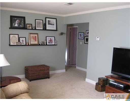 22 Kenmore Road Edison, NJ 08817 - Photo 3 of 11 a living room with furniture and a flat screen tv