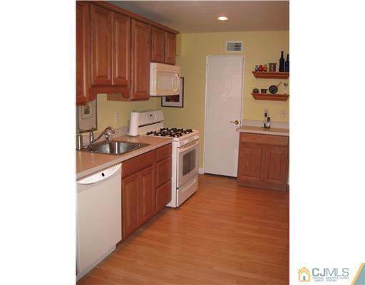 22 Kenmore Road Edison, NJ 08817 - Photo 4 of 11 a kitchen with stainless steel appliances granite countertop a stove a sink and a refrigerator