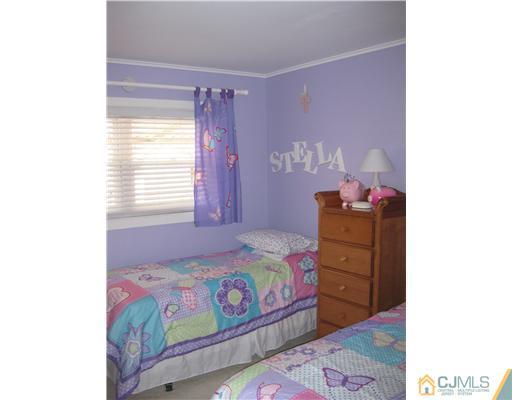 22 Kenmore Road Edison, NJ 08817 - Photo 8 of 11 a bedroom with a bed and a dresser in it