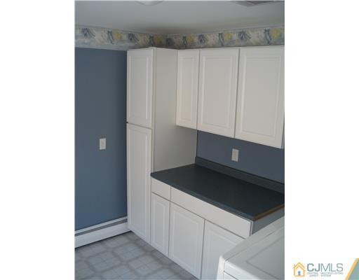 22 Kenmore Road Edison, NJ 08817 - Photo 10 of 11 a kitchen with a sink and cabinets