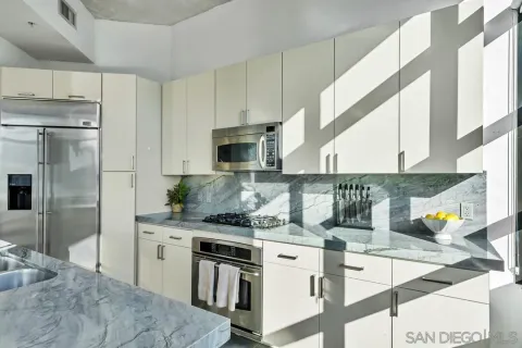 a kitchen with stainless steel appliances kitchen island granite countertop a sink and a stove