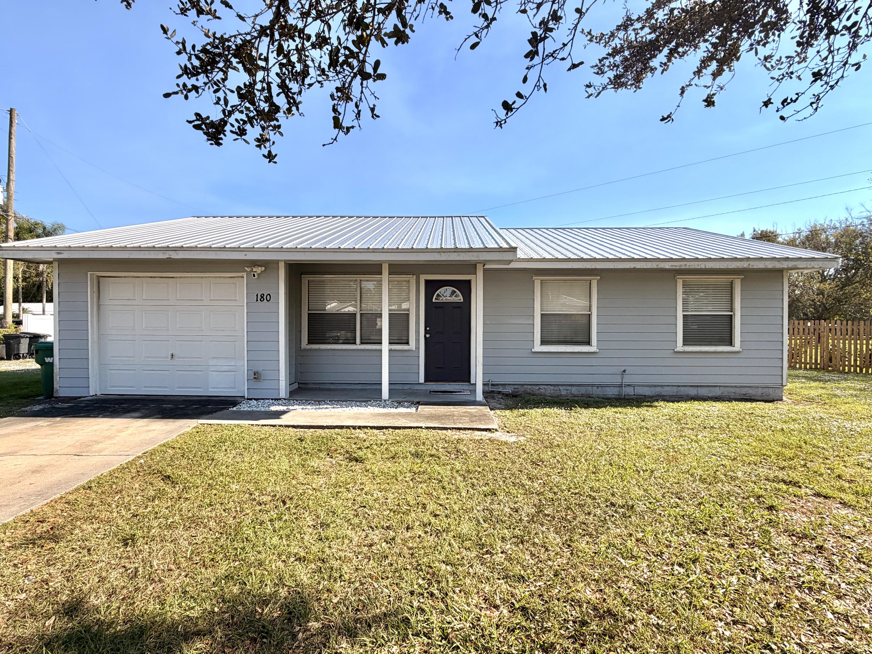 180 Southwest 21st Avenue Okeechobee, FL 34974 - Photo 1 of 21 a house view with a garden space